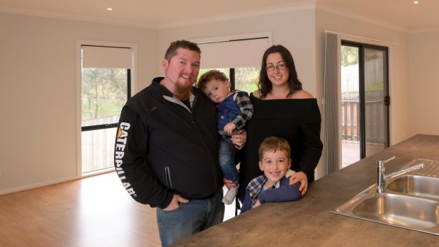 Christopher Curry and Jacqueline Kirby with their children inside their new home.
