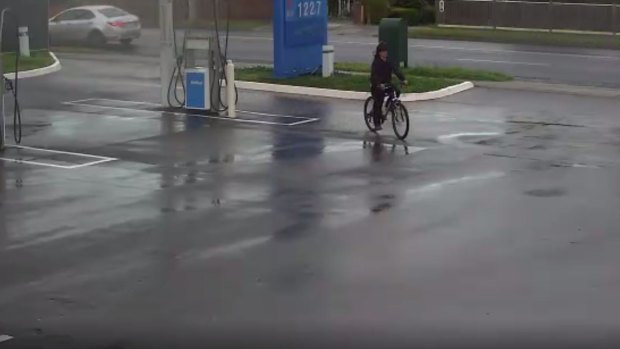 CCTV footage of the man cycling through a petrol station.