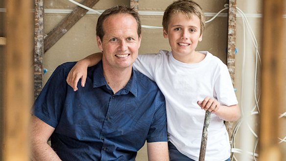 Scott Moffat with his son during the renovation.