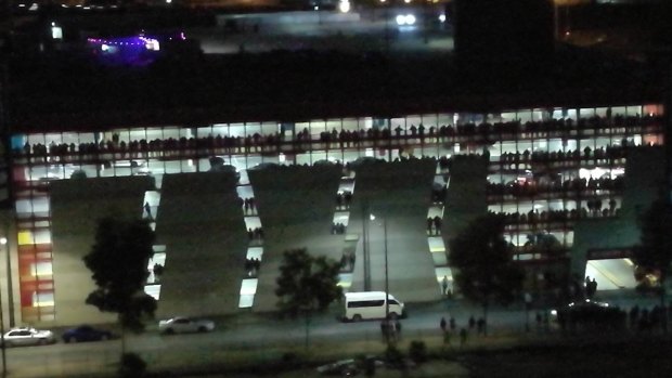 Revellers packed the balconies of the multi-storey carpark to watch cars doing burnouts on the road.