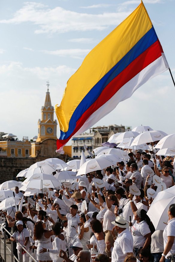 People wait for the start of the peace ceremony in Cartagena, Colombia on Monday.