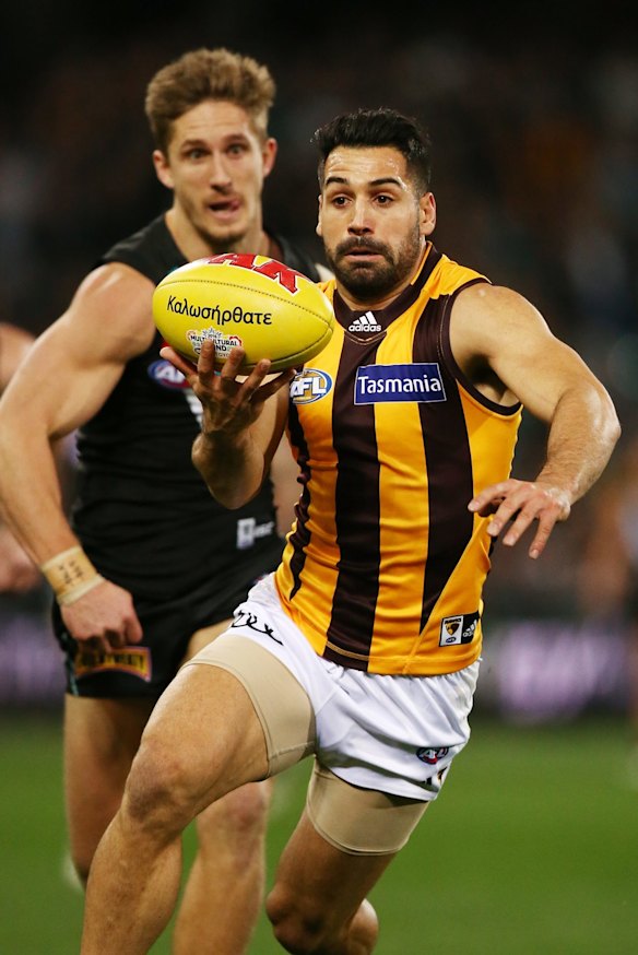The Hawks' Paul Puopolo stays one step ahead of Port Adelaide's Hamish Hartlett in the round 16 match at Adelaide Oval. 