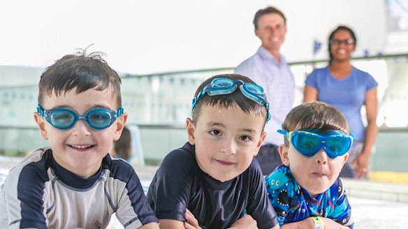 Six year old twins Joey and Ben get ready for swimming lessons at Ian Thorpe Pool in Ultimo.