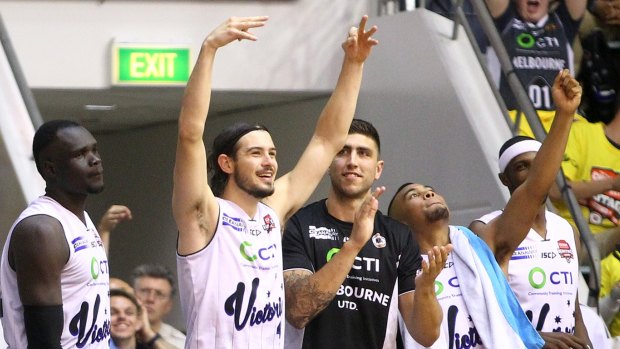 Chris Goulding, centre, celebrates with teammates a late three-pointer in their win over Cairns Taipans.