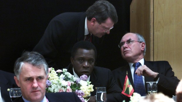 In this 2002 file photo, Lynton Crosby speaks with John Howard, with Malcolm Turnbull in the foreground. 