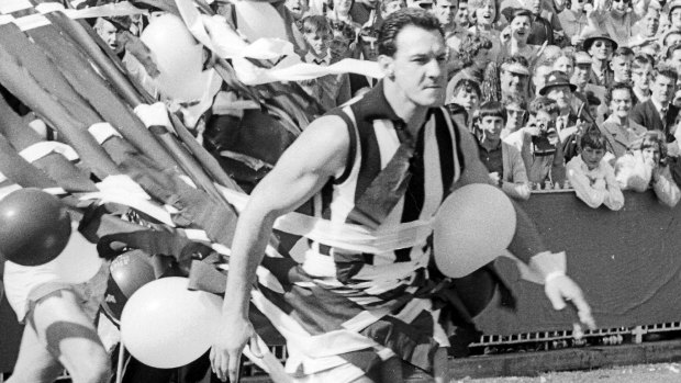 Ray Gabelich leads the Collingwood team onto the ground in the 1964 grand final.