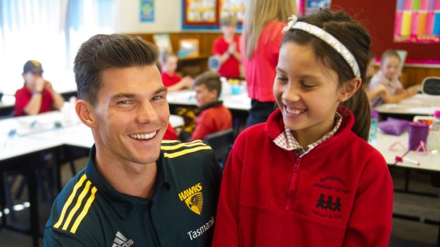 Back in town: Jaeger O'Meara visits Summerdale primary school in Launceston on Thursday where he meets fan Jessica Murray, 10.