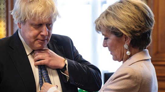 British Foreign Secretary Boris Johnson has his tie straightened by his Australian counterpart, Foreign Minister Julie Bishop.