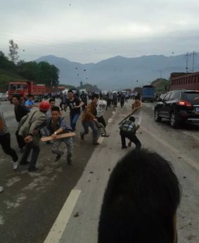 Protesters hurl rocks at the confrontation in Linshui.