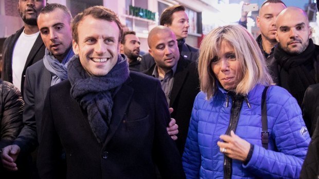 Emmanuel Macron and his wife, Brigitte Trogneux, walk to a restaurant in Paris.