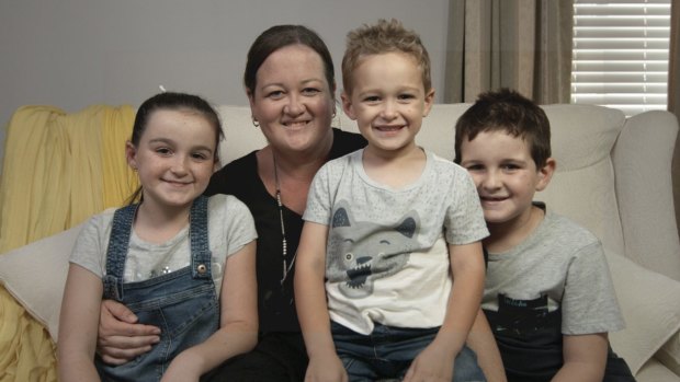 Maddy, now a "happy, healthy, very active" 10-year-old, with her mother Kristy and her two brothers.