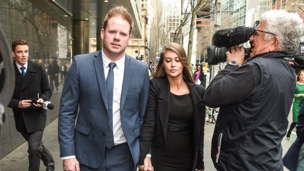 Former Carlton footballer Nick Stevens, with his new partner, leaves the County Court, where he admitted assaulting his former partner. 