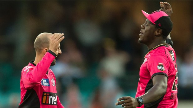 Star import: Carlos Brathwaite celebrates a wicket with SIxers teammate Nathan Lyon.