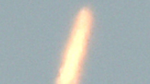 An unidentified object – thought to be North Korea's rocket launch – is photographed from Dandong, China, on Sunday.