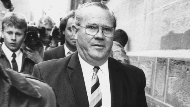 Rex "Buckets" Jackson, the former prisons minister, is led into court in handcuffs in 1987.