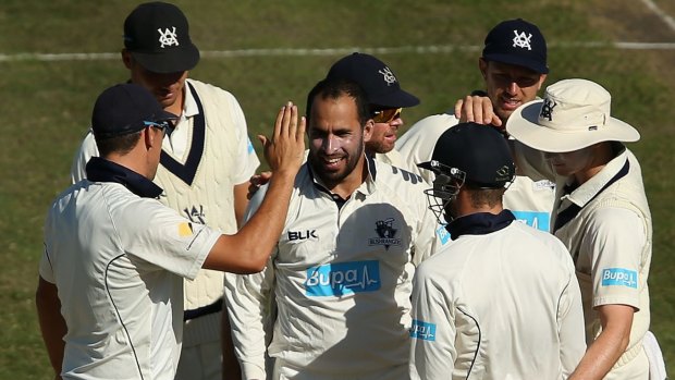 Fawad Ahmed of Victoria celebrates with team-mates after taking the wicket of Shaun Marsh of Western Australia.
