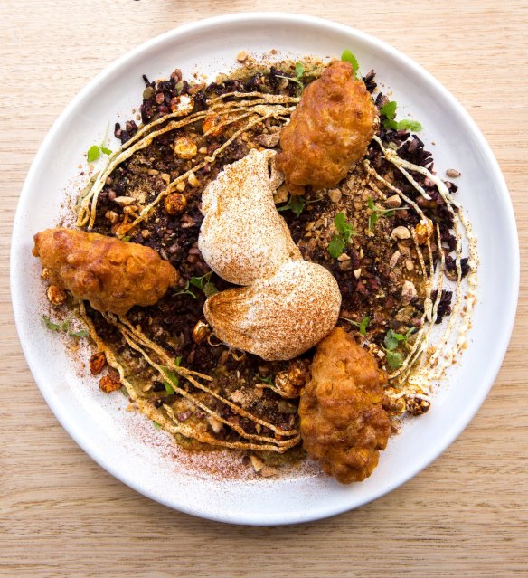 Corn fritters with black rice, baba ghanoush, kimchi popcorn and poached eggs.
