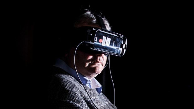Lynette Wallworth's 'Collisions' virtual reality film blends oral history, film, and sci-fi into a visceral immersive experience. Journalist Ron Cerabona is pictured trying the experience.