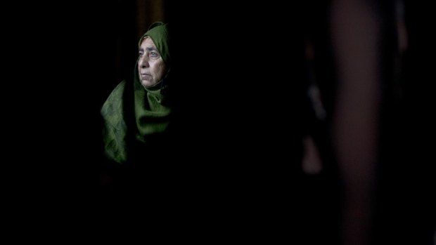 A Palestinian woman sits inside her home after an arson attack in Khirbet Abu Falah, north-east of Ramallah. The family blamed the attack on Jewish settlers. Critics fear Israel's new 'Jewish state law' will lead to discrimination against Arabs.
