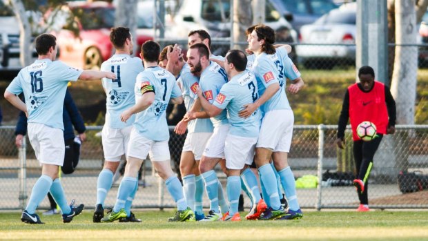 Belconnen United players celebrate their first goal.