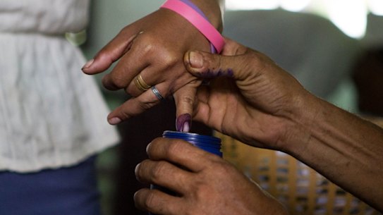 A woman's finger is dipped in ink after casting her ballot in Dala, a village outside of Yangon, Myanmar, Sunday, Nov. 8, 2015. Myanmar voted Sunday in historic elections that will test whether popular mandate will help loosen the military?s longstanding hold on power even if opposition leader Aung San Suu Kyi?s party secures a widely-expected victory. (AP Photo/Amanda Mustard)