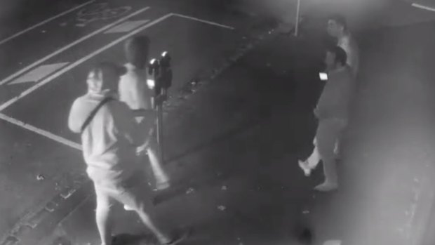 CCTV footage shows two men, one of them armed, approaching the two male victims.
