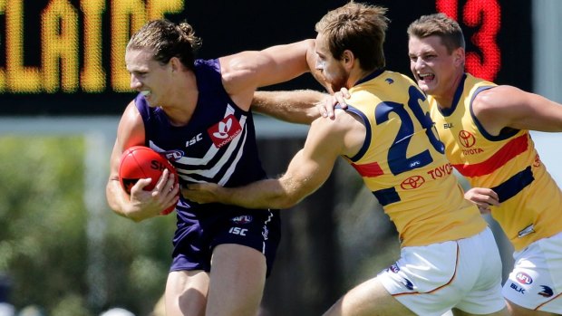Nathan Fyfe fends off a tackle in the NAB Challenge.