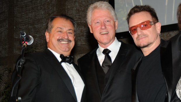 Outgoing Dow Chemical chairman and the man he's funnelled millions of Dow shareholders' dollars to, former US president Bill Clinton. And Bono, of course.