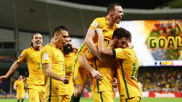 Crucial win: Mathew Leckie celebrates his goal with Socceroos teammates.