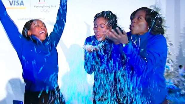 Ground-breakers: Ngozi Onwumere, Akuoma Omeoga and Seun Adigun play with fake snow during a media event in New York. The trio are representing Nigeria as the country fields its first-ever bobsled team at the Winter Olympics in Pyeongchang. The team is also a first, men's or women's, for the entire continent of Africa.