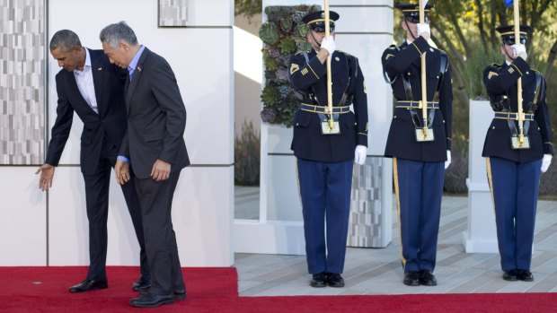 US President Barack Obama, left, guides Singapore Prime Minister Lee Hsien Loong to the right photo spot at the ASEAN meeting in California.