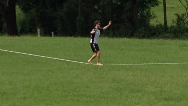 A young man practises his slacklining at North Ryde at the weekend.