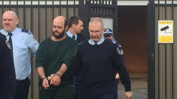 Marcus Stanford is escorted into Leeton court on Tuesday morning.