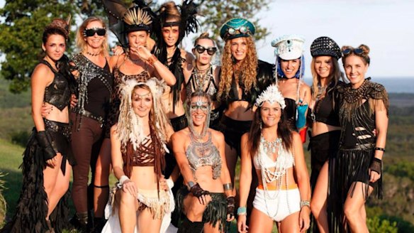 Miley Cyrus, centre back, and her crew on New Years Eve in Byron Bay.