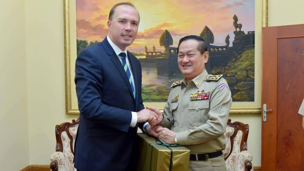 Australian Immigration Minister Peter Dutton with Sok Phal, director of the Cambodian Interior Ministry's immigration department last year. 