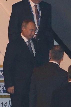 Putin steps onto the tarmac.