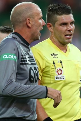 Glory coach Kenny Lowe in heated discussion with referee Shaun Evans at the half-time break.