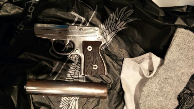 A pistol and silencer seized in a raid in Erskine Park on Thursday.