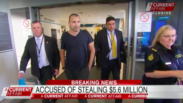 Detectives escort Daniel Albert through Sydney Airport.