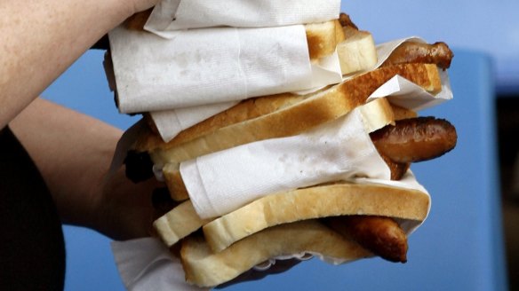 Sausage sizzle snags in bread.