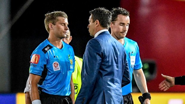 Please explain: Paul Okon speaks with the referee after two red cards marred the Mariners' clash with the Wanderers.