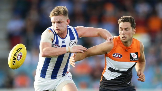 Wanted man: Josh Kelly of the Giants challenges Jack Ziebell of the Kangaroos for possession.