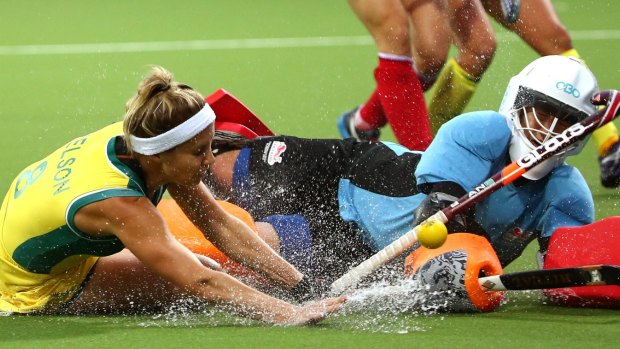 Desperate struggle: Ashleigh Nelson of Australia collides with goalkeeper Maddie Hinch of England.