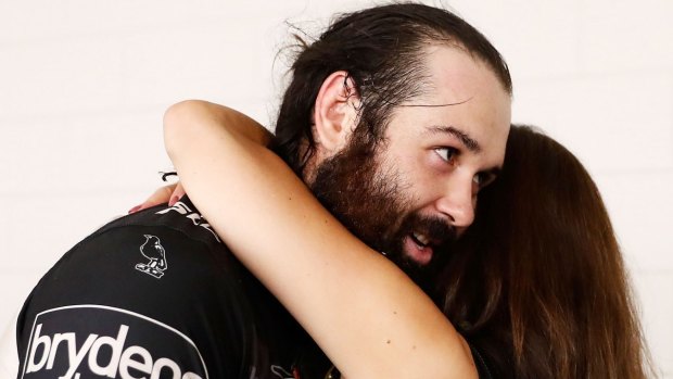 Moral support: Tigers chair Marina Go hugs Aaron Woods after their recent upset win over the Cowboys.