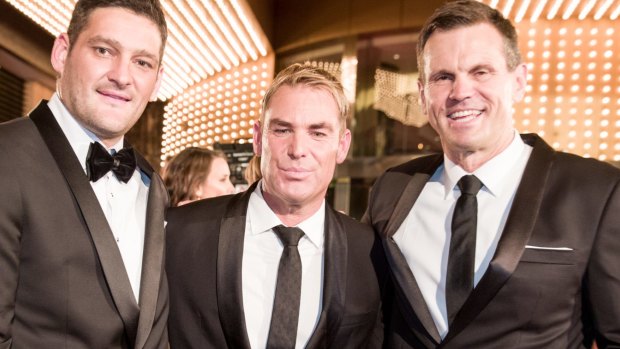 Shane Warne, flanked by Brendan Fevola and Paul Harragon, looks uncomfortable posing for a Fairfax Media photograph at the Logie Awards.