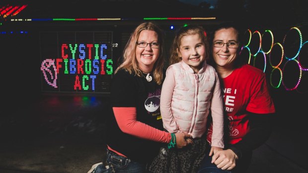 Anna Pryor puts Christmas lights up to rasie money for disease. From left, Anna Pryor, Harriett 6, and Harriett's mum Melissa. 