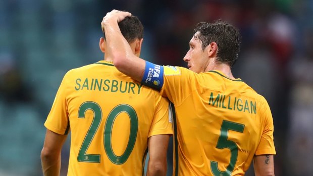 Trent Sainsbury and Mark Milligan embrace after their loss to Germany.