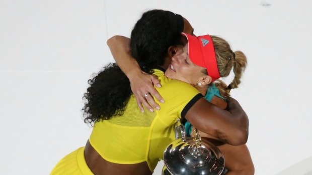 Gracious: Serena Williams embraces Angelique Kerber.
