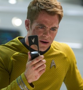 Chris Pine as Captain Kirk, using his very 90s flip-phone-like communicator.