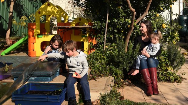 Elizabeth Slakey with her children (from left) Luca, 8, Declan, 5, and Pippi, 2: Valuations for the family's Haberfield home differ by nearly $350,000.